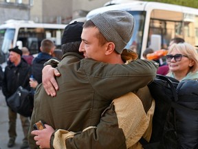 Russian reservists bid farewell to relatives and acquaintances before their departure for a base in the course of partial mobilization of troops, in Omsk, Russia Oct. 7.