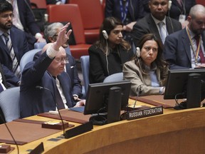 Russian Ambassador to the United Nations Vasily Nebenzya raises his hand against a U.N. Security Council vote on a draft resolution sanctioning Russia's planned annexation of war-occupied Ukraine territory, Friday Sept. 30, 2022 at U.N. headquarters.