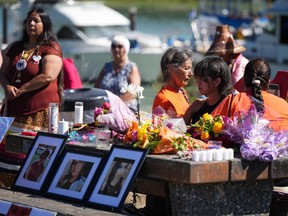 Natasha Harrison, second right, is comforted during a vigil for her daughter Tatyanna Harrison, 20, and for Noelle O'Soup, 13, and Chelsea Poorman, 24, in Richmond, B.C., Saturday, Sept. 3, 2022. Family members of Indigenous women killed across B.C. say there needs to be more accountability and improved communication between police jurisdictions during investigations of missing people.