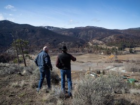 B.C. Minister of Public Safety Mike Farnworth, left, and Shackan Indian Band Chief Arnie Lampreau view damage to Shackan land caused by last summer's wildfires and November flooding west of Merritt, B.C., on Thursday, March 24, 2022.