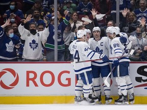 Toronto Maple Leafs' Morgan Rielly, from left to right, Mitch Marner, John Tavares, Auston Matthews and William Nylander celebrate Matthews' goal against the Vancouver Canucks during the second period of an NHL hockey game in Vancouver, on Saturday, February 12, 2022.
