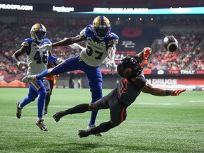 B.C. Lions' Keon Hatcher (4) fails to make the reception in the end zone as Winnipeg Blue Bombers' Brandon Alexander (37) defends and Desmond Lawrence (46) watches during first half CFL football action in Vancouver, B.C., Saturday, Oct. 15, 2022. The Winnipeg Blue Bombers (14-3) host the Lions (12-5) Friday in the regular-season finale for both CFL clubs.