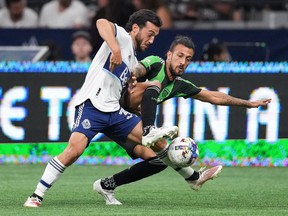 Vancouver Whitecaps' Russell Teibert, left, and Austin FC's Maxi Urruti vie for the ball during the first half of an MLS soccer game in Vancouver, on Saturday, October 1, 2022.&ampnbsp;Teibert has undergone successful surgery on his right ankle. THE&ampnbsp;CANADIAN PRESS/Darryl Dyck