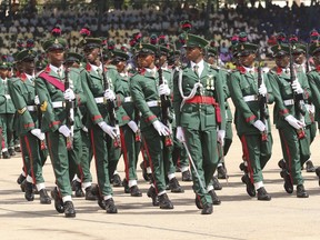 FILE - Nigerian soldiers march during 62nd anniversary celebrations of Nigerian independence, in Abuja, Nigeria, Oct. 1, 2022. The State Department has ordered the families of U.S. embassy staffers in the Nigerian capital to leave due to heightened fears of a terrorist attack.
