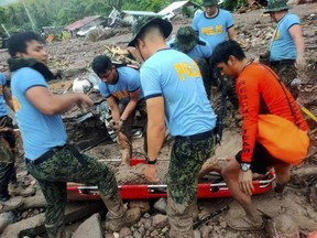 Several people died while others were missing in flash floods and landslides set off by torrential rains from Tropical Storm Nalgae that swamped a southern Philippine province overnight and trapped some residents on their roofs, officials said Friday.