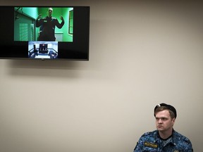 Russian opposition leader Alexei Navalny is seen on a TV screen as he appears in a video link provided by the Russian Federal Penitentiary Service in a courtroom of the Second Cassation Court of General Jurisdiction in Moscow, Russia, Tuesday, Oct. 18, 2022. Earlier this year, Navalny was sentenced to nine years in prison on the charges of fraud and contempt of court. This is his second appeal of the conviction, he lost the first one in May this year.