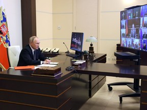 Russian President Vladimir Putin chairs a Security Council meeting via videoconference at the Novo-Ogaryovo residence outside Moscow, Russia, Wednesday, Oct. 19, 2022.