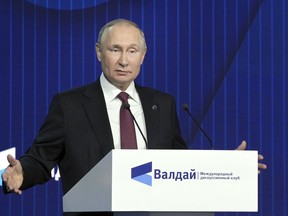 Russian President Vladimir Putin gestures as he speaks at the plenary session of the 19th annual meeting of the Valdai International Discussion Club outside Moscow, Russia, Thursday, Oct. 27, 2022.