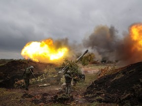 Servicemen fire from their 152-mm gun 2A36 «Giatsint-B» howitzer from their position at Ukrainian troops at an undisclosed location in Donetsk People's Republic, eastern Ukraine, Tuesday, Oct. 11, 2022.