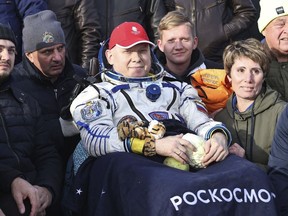 In this image distributed by Roscosmos State Space Corporation, Russian cosmonaut Oleg Artemyev sits in the chair shortly after the landing of the Russian Soyuz MS-21 space capsule southeast of the Kazakh town of Zhezkazgan, Kazakhstan, Thursday, Sept. 29, 2022. Three Russian cosmonauts returned safely from a mission to the International Space Station. The Soyuz MS-21 spacecraft carrying Oleg Artemyev, Denis Matveyev and Sergey Korsakov touched down softly at 4:57 p.m. (1057 GMT) Thursday at a designated site in the steppes of Kazakstan about 150 kilometers (about 90 miles) southeast of the city of Zhezkazgan.