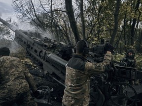 Ukrainian soldiers fire at Russian positions from a U.S.-supplied M777 howitzer in Ukraine's eastern Donetsk region Sunday, Oct. 23, 2022.