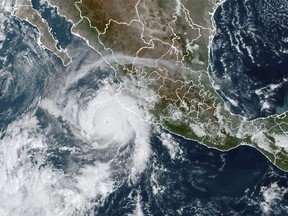 This satellite image taken at 15:30 UTC and provided by NOAA shows Tropical Storm Roslyn approaching the Pacific coast of Mexico, Saturday, Oct. 22, 2022. Roslyn grew to Category 4 force on Saturday as it headed for a collision with Mexico's Pacific coast, likely north of the resort of Puerto Vallarta. (NOAA via AP)