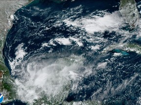 This satellite image taken at 2:16pm ET and provided by NOAA shows Tropical Storm Karl over the Yucatan Peninsula and Chiapas, Mexico, Friday, Oct. 14, 2022. (NOAA via AP)