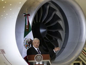 FILE - Mexican President Andres Manuel Lopez Obrador gives his daily, morning press conference in front of the former presidential plane at Benito Juarez International Airport in Mexico City, July 27, 2020. Obrador said Tuesday, Oct. 4, 2022 that his government is analyzing the creation of a state-owned, army-run airline that would fly 10 leased airplanes as well as the former presidential jet.