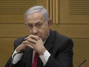 FILE - Former Israeli Prime Minister Benjamin Netanyahu speaks to right-wing opposition party members, at the Knesset, Israel's parliament, in Jerusalem, June 14, 2021. Netanyahu was hospitalized on Wednesday, Oct. 5, 2022, after feeling unwell during the Jewish fasting day of Yom Kippur.