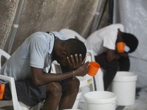Patients with cholera symptoms sit in an observation center at a cholera clinic run by Doctors Without Borders in Port-au-Prince, Haiti, Friday, Oct. 7, 2022.
