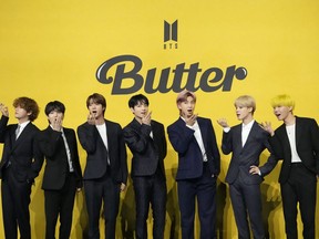 FILE- Members of South Korean K-pop band BTS, V, SUGA, JIN, Jung Kook, RM, Jimin, and j-hope from left to right, pose for photographers ahead of a press conference to introduce their new single "Butter" in Seoul, South Korea, Friday, May 21, 2021. South Korea's military appears to want to draft members of the K-pop supergroup BTS for mandatory military duties, as the pubic are sharply divided over whether they must be exempted from the service.