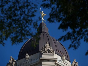 The Golden Boy stands on top of the dome of the Manitoba Legislature in Winnipeg, Saturday, Aug. 30, 2014. The Manitoba government has introduced a bill in the legislature to formally enact a raise in the minimum wage.