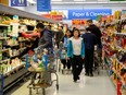 FILE PHOTO: People gather supplies at a grocery store amid coronavirus fears spreading in Toronto,