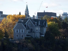 The Canadian prime ministers' residence, 24 Sussex, is seen on the banks of the Ottawa River in Ottawa on Monday, Oct. 26, 2015. The Parliament Hill Peace Tower is in the distance.