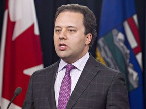 Alberta Justice Minister Jonathan Denis attends a news conference in Edmonton on Thursday Aug 7, 2014.