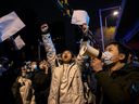 Protesters shout slogans during a protest against Chinas strict zero COVID measures on November 28, 2022 in Beijing, China. Protesters took to the streets in multiple Chinese cities after a deadly apartment fire in Xinjiang province sparked a national outcry as many blamed COVID restrictions for the deaths. 