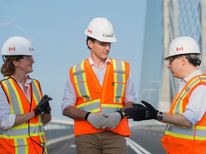  Prime Minister Justin Trudeau, centre, takes a tour of the new Champlain Bridge in Montreal, Sunday, June 23, 2019, with Senior director of the New Champlain bridge project Chantale Cote, left, and federal Infrastructure Minister Francois-Philippe Champagne.