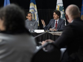 Inuit Tapiriit Kanatami president Natan Obed looks on as Prime Minister Justin Trudeau makes opening remarks at a meeting of the Inuit-Crown Partnership Committee, in Ottawa, Thursday, April 21, 2022. The federal government and Inuit Tapiriit Kanatami, an organization representing Inuit in Canada, have announced $6.4 million in funding to establish an Inuit Research Network.