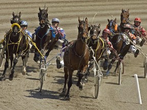 Drivers and horses head into a turn during harness racing action in the 2008 opening day program at the Charlottetown Driving Park in Charlottetown on Saturday, April 19, 2008. Doug McNair won the opening two races and never looked back, easily capturing his second Canadian driving championship.