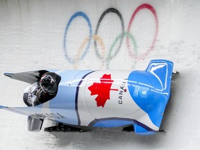 Christine De Bruin and Kristen Bujnowski, of Canada, slide during the women's bobsleigh heat 3 at the 2022 Winter Olympics, in the Yanqing district of Beijing, Saturday, Feb. 19, 2022. De Bruin has been suspended for three years for a doping violation.