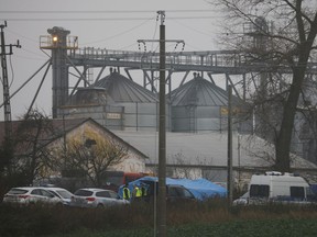Police officers work outside a grain depot where, according to the Polish government, an explosion of a Russian-made missile killed two people in Przewodow, Poland, Wednesday, Nov. 16, 2022. As the investigation continues into how two Poles died in an explosion near their country's border with Ukraine on Tuesday, Poland's ambassador to Canada is urging the international community to consider deepening its support for the countries closest to the war.THE CANADIAN PRESS/AP, Michal Dyjuk