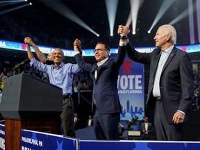 President Joe Biden stands on stage with Pennsylvania's Democratic gubernatorial candidate Josh Shapiro, second from right, former President Barack Obama, left, and Democratic Senate candidate Lt. Gov. John Fetterman, obscured, at the end of a campaign rally Saturday, Nov. 5, 2022, in Philadelphia.