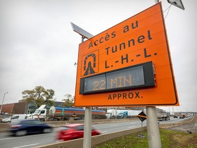 An electric sign gives motorists an update on the status of traffic heading to the Tunnel Louis-Hippolyte-Lafontaine along Highway 40 near the Lacordaire exit, in Montreal on Oct. 31, 2022. Three of the tunnel's six lanes were closed for the first day of repairs planned to last six years.