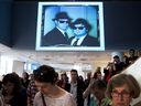 A portrait of Dan Aykroyd and John Belushi as the Blues Brothers is projected on a wall during the 2013 announcement of the donation of the Annie Leibovitz collection to the Art Gallery of Nova Scotia in Halifax.