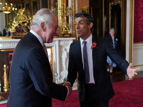 King Charles III, left, greets British Prime Minister Rishi Sunak, during a reception at Buckingham Palace in London, on Nov. 4.