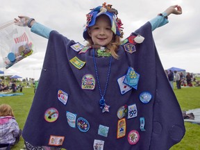 A Brownie shows her pins and badges. Girl Guides of Canada plans to announce a new name to replace "Brownies" in January.