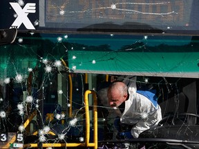 An Israeli forensic expert collects evidence at the scene of the bombing at a Jerusalem bus stop that killed 16-year-old Israeli-Canadian Aryeh Schupak on Nov. 23, 2022.