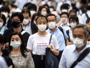 A crowd of people wearing masks for COVID protection.