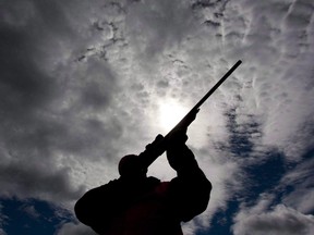 A hunter checks the sight of his rifle at a hunt camp in rural Ontario, west of Ottawa.