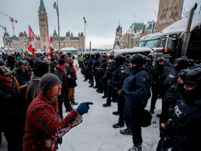 Police stare down Freedom Convoy protesters in Ottawa.