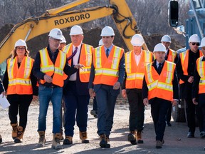 Prime Minister Justin Trudeau, centre, tours the site at the official groundbreaking ceremony for a Moderna vaccine production facility in Laval, Que., on Monday.