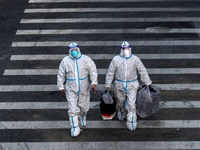 Epidemic control workers wear PPE to prevent the spread of COVID-19 as they guard in an area with communities in lockdown on December 1, 2022 in Beijing, China.