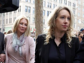 Former Theranos CEO Elizabeth Holmes, right, arrives at federal court with her mother Noel Holmes in San Jose, California, on November 18, 2022. Holmes appeared in federal court for sentencing after being convicted of four counts of fraud for allegedly engaging in a multimillion-dollar scheme to defraud investors in her company Theranos, which offered blood testing lab services.