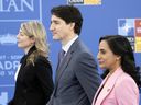 From left, Foreign Affairs Minister Mélanie Joly, Prime Minister Justin Trudeau and Defence Minister Anita Anand received a report from a parliamentary committee four months ago that raised alarms about irregularities.