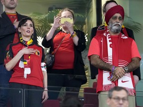 Canada's International Development Minister Harjit Sajjan, right, stands during the national anthems before the World Cup match between Belgium and Canada in Doha, Qatar, November 23, 2022. Belgium Foreign Minister Hadja Lahbib, wearing a "One Love" armband, is on the left.
