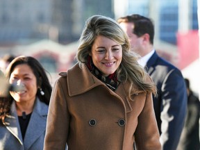 Foreign Affairs Minister Mélanie Joly, centre, with International Trade Minister Mary Ng and Public Safety Minister Marco Mendocino, obscured, arrive for a news conference to announce Canada's Indo-Pacific strategy, in Vancouver on November 27, 2022.