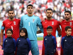 Iran players line up for the national anthem prior to the FIFA World Cup Qatar 2022 Group B match between England and IR Iran at Khalifa International Stadium on November 21, 2022 in Doha, Qatar. (Photo by Julian Finney/Getty Images)