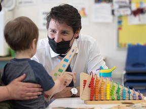 Prime Minister Justin Trudeau visits a daycare centre at Queen Elizabeth School in Saskatoon on May 25, 2022. Trudeau's promised $10-a-day childcare has been slow to materialize, writes Rahim Mohamed.