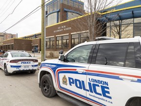 Several London police cruisers are parked outside H.B. Beal secondary school in downtown London after a female student was stabbed in the cafeteria at lunch on Monday, Nov. 21, 2022. (Mike Hensen/The London Free Press)