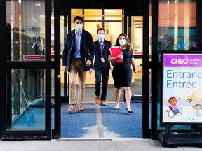 Prime Minister Justin Trudeau, left, visits the Children's Hospital of Eastern Ontario in Ottawa in 2021.